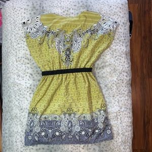 Grey green and black tunic with black belt.